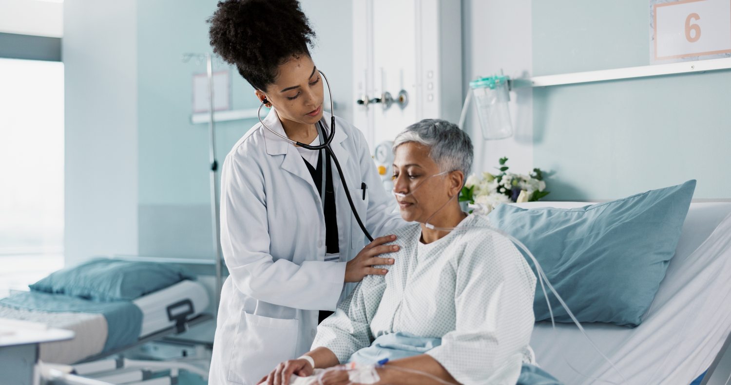 A doctor caring for a hospitalized patient at the bedside