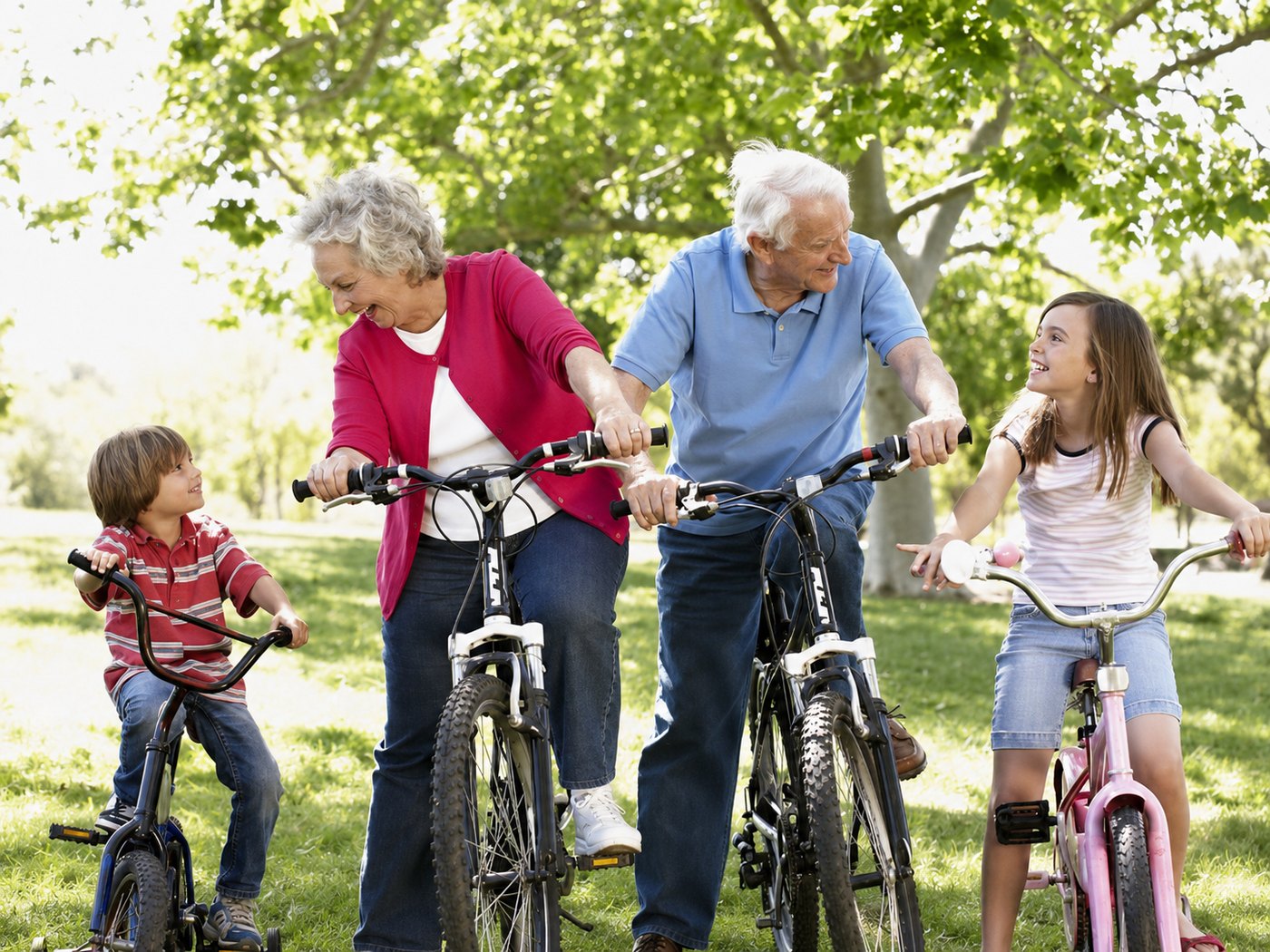 A grandfather laughing with his two grandchildren